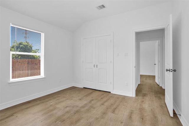 0 Basswood St, Houston, TX 77022 - unfurnished bedroom with vaulted ceiling, light wood-type flooring, a closet, and baseboards