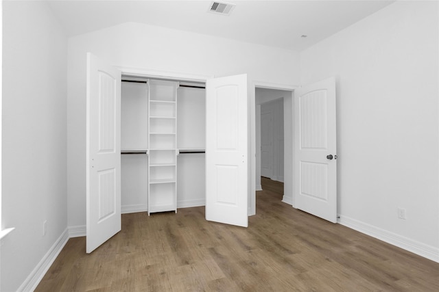 0 Basswood St, Houston, TX 77022 - unfurnished bedroom featuring wood finished floors, baseboards, and a closet