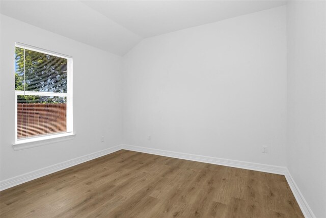 0 Basswood St, Houston, TX 77022 - empty room featuring wood finished floors, baseboards, and lofted ceiling