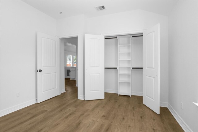 0 Basswood St, Houston, TX 77022 - unfurnished bedroom featuring wood finished floors, a closet, and baseboards