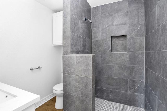 0 Basswood St, Houston, TX 77022 - bathroom with walk in shower, toilet, wood finished floors, vanity, and baseboards