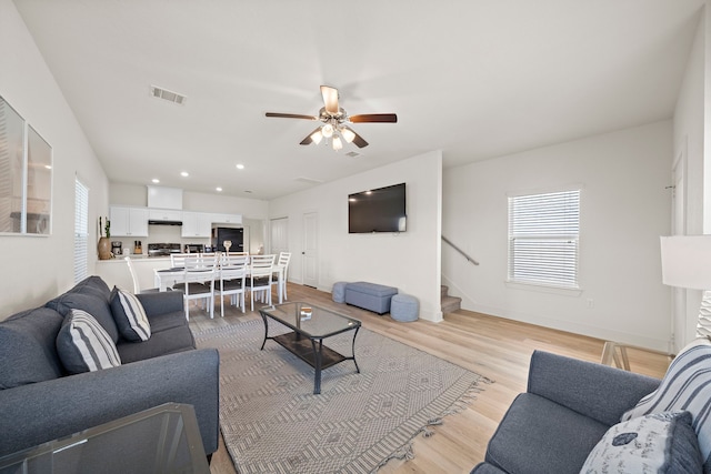 3610 Sealy St, Galveston, TX 77550 - living area featuring a ceiling fan, stairs, light wood-type flooring, baseboards, and recessed lighting