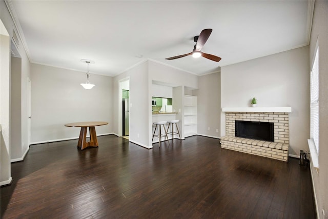 726 Bering Dr Unit F, Houston, TX 77057 - unfurnished living room featuring a ceiling fan, dark wood-type flooring, ornamental molding, a brick fireplace, and built in shelves