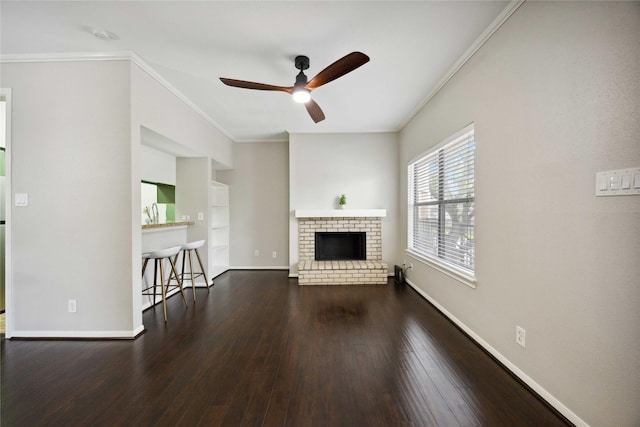 726 Bering Dr Unit F, Houston, TX 77057 - unfurnished living room featuring crown molding, ceiling fan, wood finished floors, a brick fireplace, and built in features
