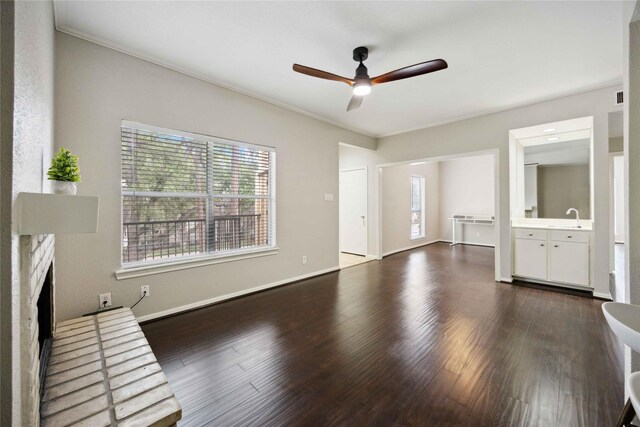 726 Bering Dr Unit F, Houston, TX 77057 - unfurnished living room featuring ceiling fan, plenty of natural light, a brick fireplace, dark wood-style floors, and ornamental molding