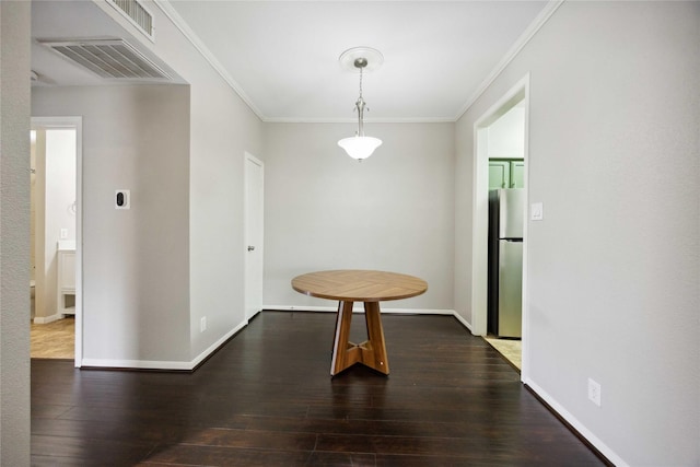 726 Bering Dr Unit F, Houston, TX 77057 - unfurnished dining area featuring crown molding and dark wood-style flooring