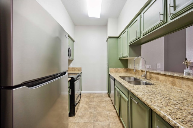 726 Bering Dr Unit F, Houston, TX 77057 - kitchen with stainless steel appliances, green cabinets, and light stone counters