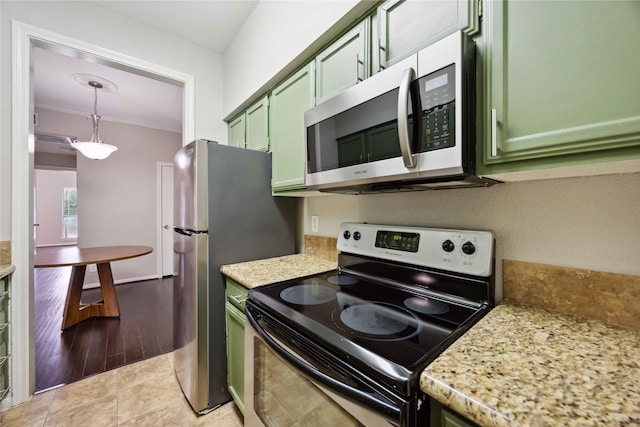 726 Bering Dr Unit F, Houston, TX 77057 - kitchen with green cabinets, appliances with stainless steel finishes, decorative light fixtures, light tile patterned flooring, and ornamental molding