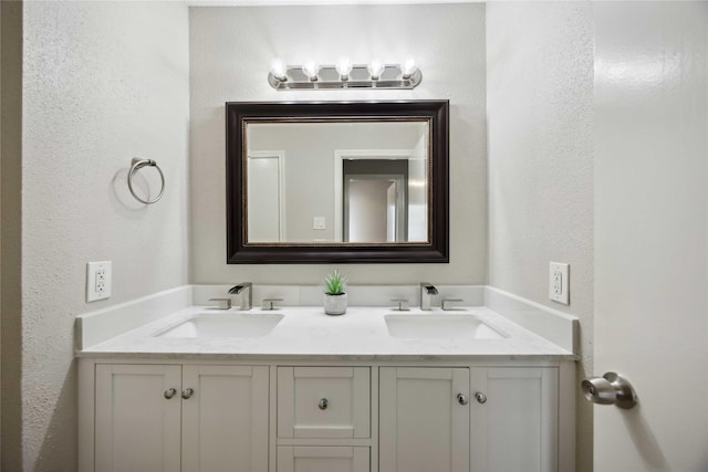 726 Bering Dr Unit F, Houston, TX 77057 - full bathroom featuring double vanity and a textured wall
