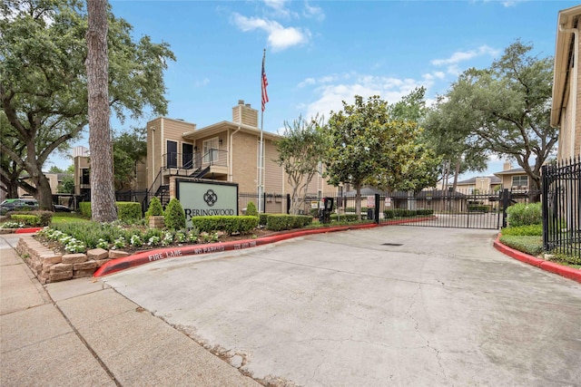 726 Bering Dr Unit F, Houston, TX 77057 - view of concrete road with curbs, a gate, and a gated entry