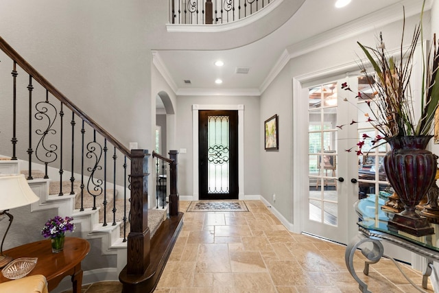74 Spincaster Dr, Spring, TX 77389 - foyer featuring stone tile flooring, arched walkways, ornamental molding, stairs, and french doors