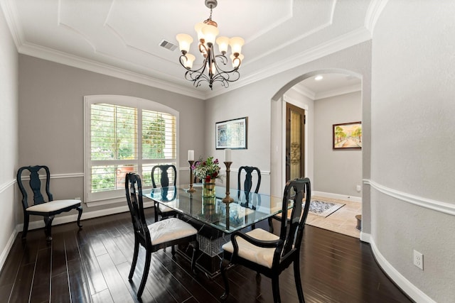 74 Spincaster Dr, Spring, TX 77389 - dining area featuring arched walkways, a chandelier, dark wood finished floors, ornamental molding, and a tray ceiling