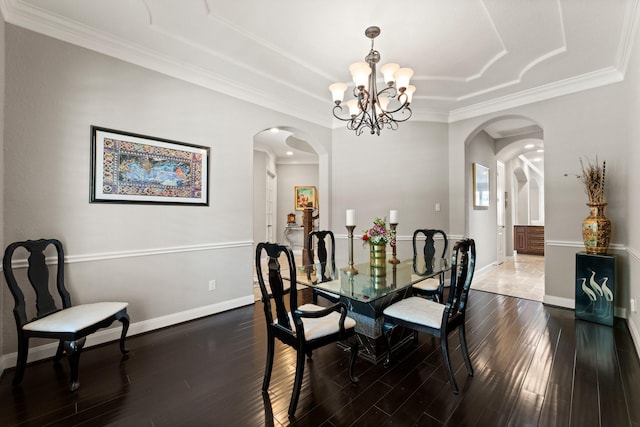 74 Spincaster Dr, Spring, TX 77389 - dining area with a tray ceiling, arched walkways, a chandelier, dark wood-type flooring, and crown molding