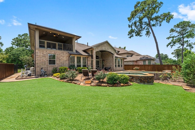 74 Spincaster Dr, Spring, TX 77389 - rear view of house with brick siding, a fenced backyard, an in-ground hot tub, and a patio