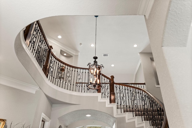 74 Spincaster Dr, Spring, TX 77389 - staircase with a chandelier, recessed lighting, crown molding, and arched walkways