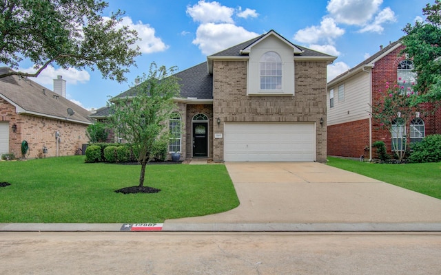 12807 Sienna Trails Dr, Tomball, TX 77377 - traditional-style home with brick siding, concrete driveway, a garage, and a front yard