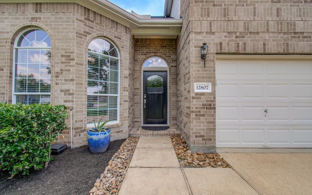 12807 Sienna Trails Dr, Tomball, TX 77377 - property entrance with brick siding and a garage