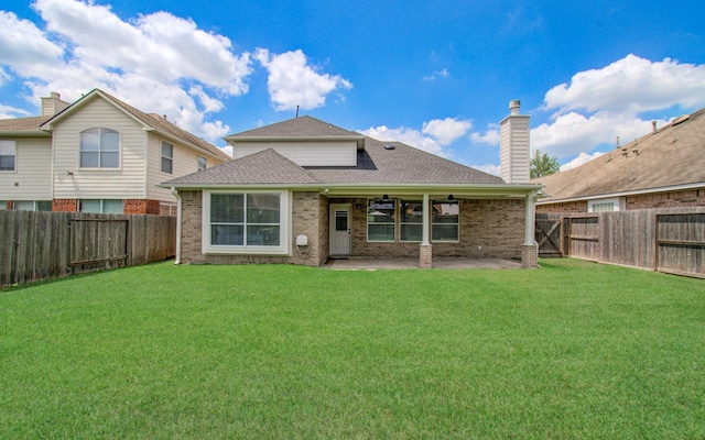 12807 Sienna Trails Dr, Tomball, TX 77377 - back of house with a ceiling fan, brick siding, a shingled roof, and a patio
