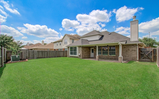 12807 Sienna Trails Dr, Tomball, TX 77377 - rear view of property with brick siding, a shingled roof, a patio area, a chimney, and a ceiling fan