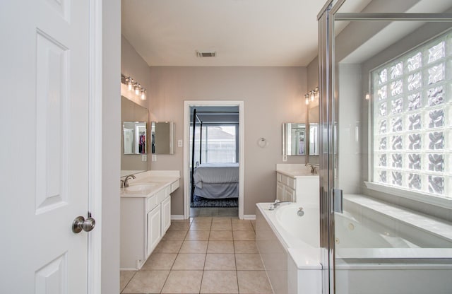 12807 Sienna Trails Dr, Tomball, TX 77377 - full bath with a bath, two vanities, tile patterned floors, and baseboards