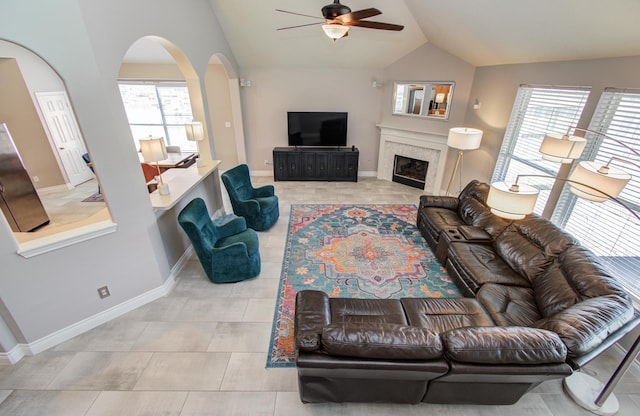 12807 Sienna Trails Dr, Tomball, TX 77377 - living area with ceiling fan, vaulted ceiling, arched walkways, healthy amount of natural light, and baseboards