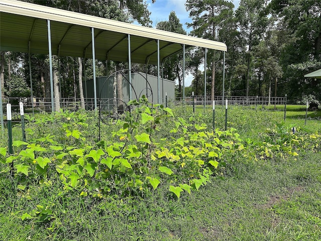 24338 Redbud Ave, Porter, TX 77365 - view of yard featuring a detached carport and view of wooded area