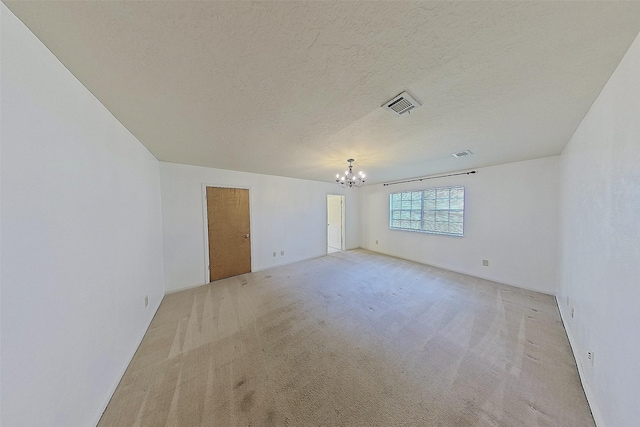 24338 Redbud Ave, Porter, TX 77365 - spare room featuring a chandelier, carpet flooring, and a textured ceiling