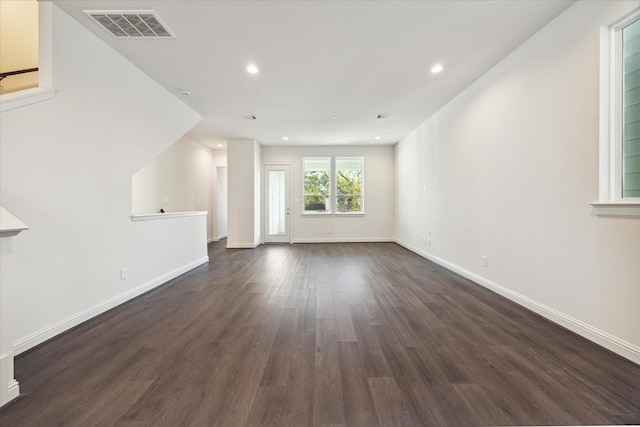 1805 Mills St, Houston, TX 77026 - unfurnished living room with dark wood-type flooring, baseboards, and recessed lighting
