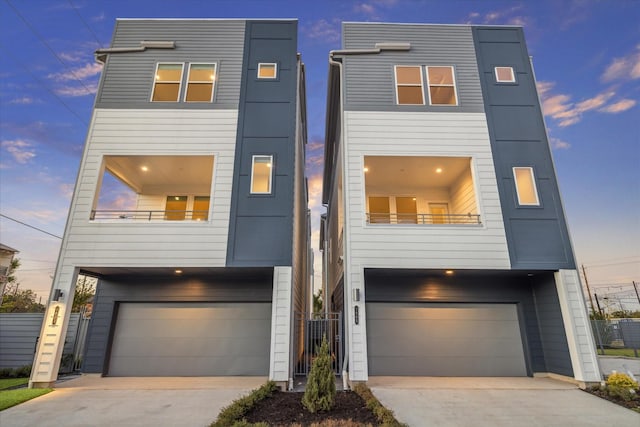 1805 Mills St, Houston, TX 77026 - view of front facade with a garage, concrete driveway, and a balcony