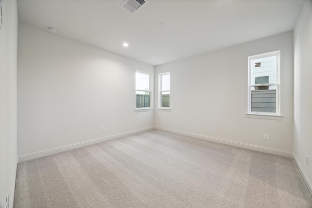 1805 Mills St, Houston, TX 77026 - unfurnished room featuring light carpet, a smoke detector, baseboards, and recessed lighting