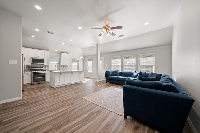 146 S Star Ridge Cir, The Woodlands, TX 77382 - living area featuring healthy amount of natural light, ceiling fan, light wood-style floors, baseboards, and recessed lighting