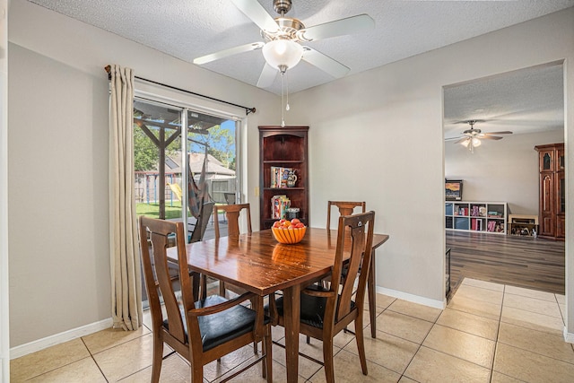 1826 Concho River Ct, Sugar Land, TX 77478 - dining space featuring a ceiling fan, a textured ceiling, light tile patterned floors, and baseboards
