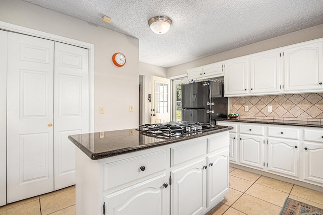 1826 Concho River Ct, Sugar Land, TX 77478 - kitchen featuring black appliances, light tile patterned floors, white cabinetry, and a textured ceiling
