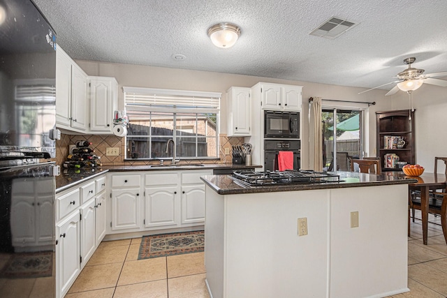 1826 Concho River Ct, Sugar Land, TX 77478 - kitchen with a sink, black appliances, white cabinets, backsplash, and a textured ceiling