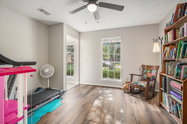 1826 Concho River Ct, Sugar Land, TX 77478 - exercise area featuring wood finished floors, a textured ceiling, ceiling fan, and baseboards