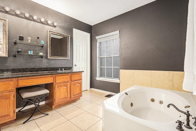 1826 Concho River Ct, Sugar Land, TX 77478 - full bathroom with a whirlpool tub, vanity, tile patterned floors, a textured wall, and a textured ceiling