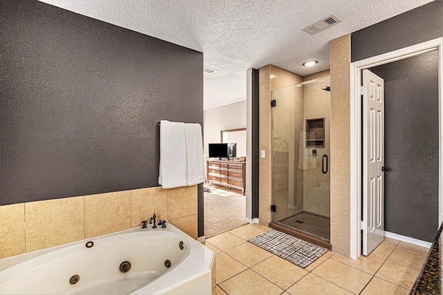 1826 Concho River Ct, Sugar Land, TX 77478 - bathroom with a shower stall, a whirlpool tub, tile patterned floors, and a textured ceiling