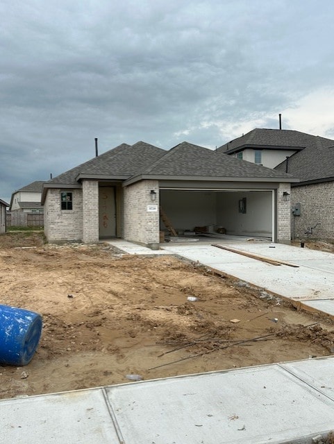 31726 Autumn Spur Ln, Hockley, TX 77447 - view of front of house featuring brick siding, roof with shingles, a garage, and driveway