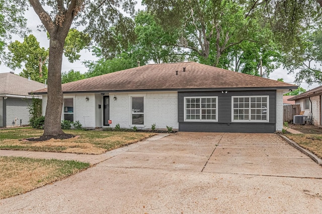 6023 Viking Dr, Houston, TX 77092 - ranch-style house with central AC unit, brick siding, and roof with shingles