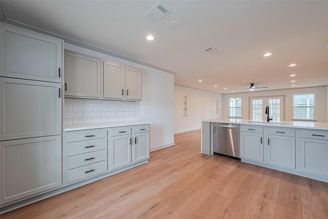 6023 Viking Dr, Houston, TX 77092 - kitchen with dishwasher, a sink, light wood-type flooring, recessed lighting, and decorative backsplash