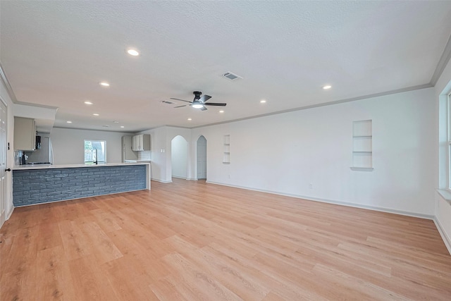 6023 Viking Dr, Houston, TX 77092 - unfurnished living room with light wood-style flooring, arched walkways, ceiling fan, recessed lighting, and baseboards