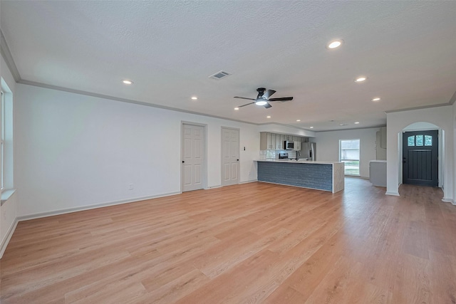 6023 Viking Dr, Houston, TX 77092 - unfurnished living room with arched walkways, a ceiling fan, light wood finished floors, baseboards, and recessed lighting