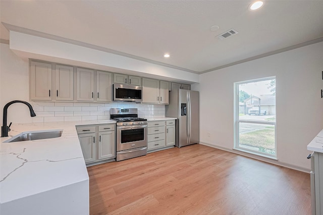6023 Viking Dr, Houston, TX 77092 - kitchen featuring stainless steel appliances, a sink, gray cabinetry, tasteful backsplash, and recessed lighting