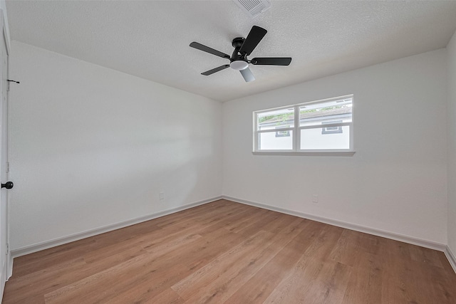 6023 Viking Dr, Houston, TX 77092 - empty room with light wood finished floors, baseboards, a textured ceiling, and a ceiling fan