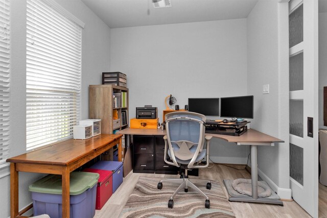 5746 Lakeside Villas Ct, Conroe, TX 77304 - home office featuring light wood-style flooring, baseboards, and healthy amount of natural light