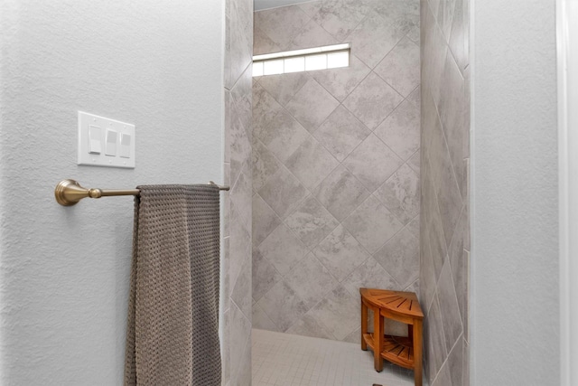 5746 Lakeside Villas Ct, Conroe, TX 77304 - full bathroom with a tile shower and a textured wall
