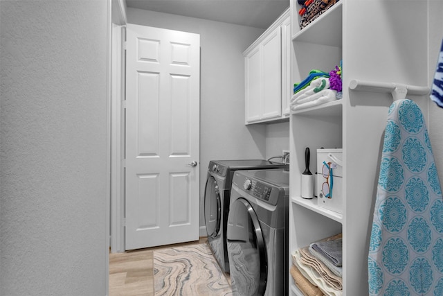 5746 Lakeside Villas Ct, Conroe, TX 77304 - laundry area with cabinet space, separate washer and dryer, and light wood-style floors