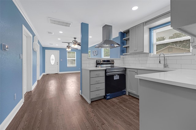 2406 W Elvinta St, Baytown, TX 77520 - kitchen with electric stove, island range hood, gray cabinetry, decorative backsplash, and ornamental molding