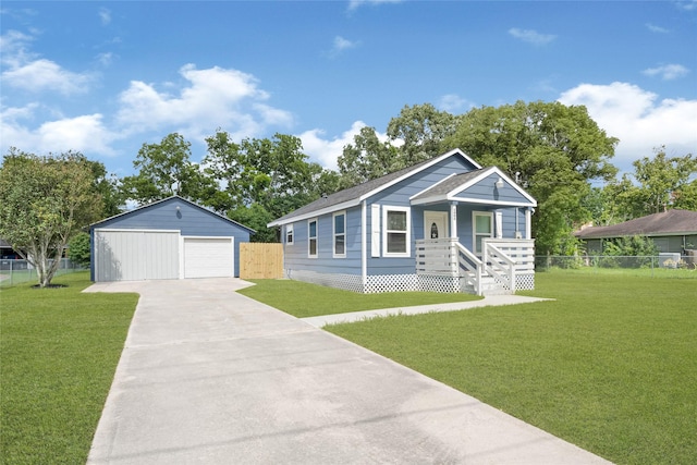 2406 W Elvinta St, Baytown, TX 77520 - view of front of home with a garage, driveway, an outbuilding, and a porch