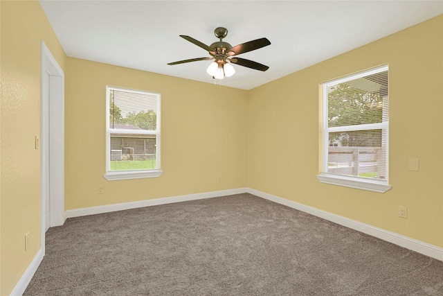 2406 W Elvinta St, Baytown, TX 77520 - carpeted empty room featuring healthy amount of natural light, ceiling fan, and baseboards
